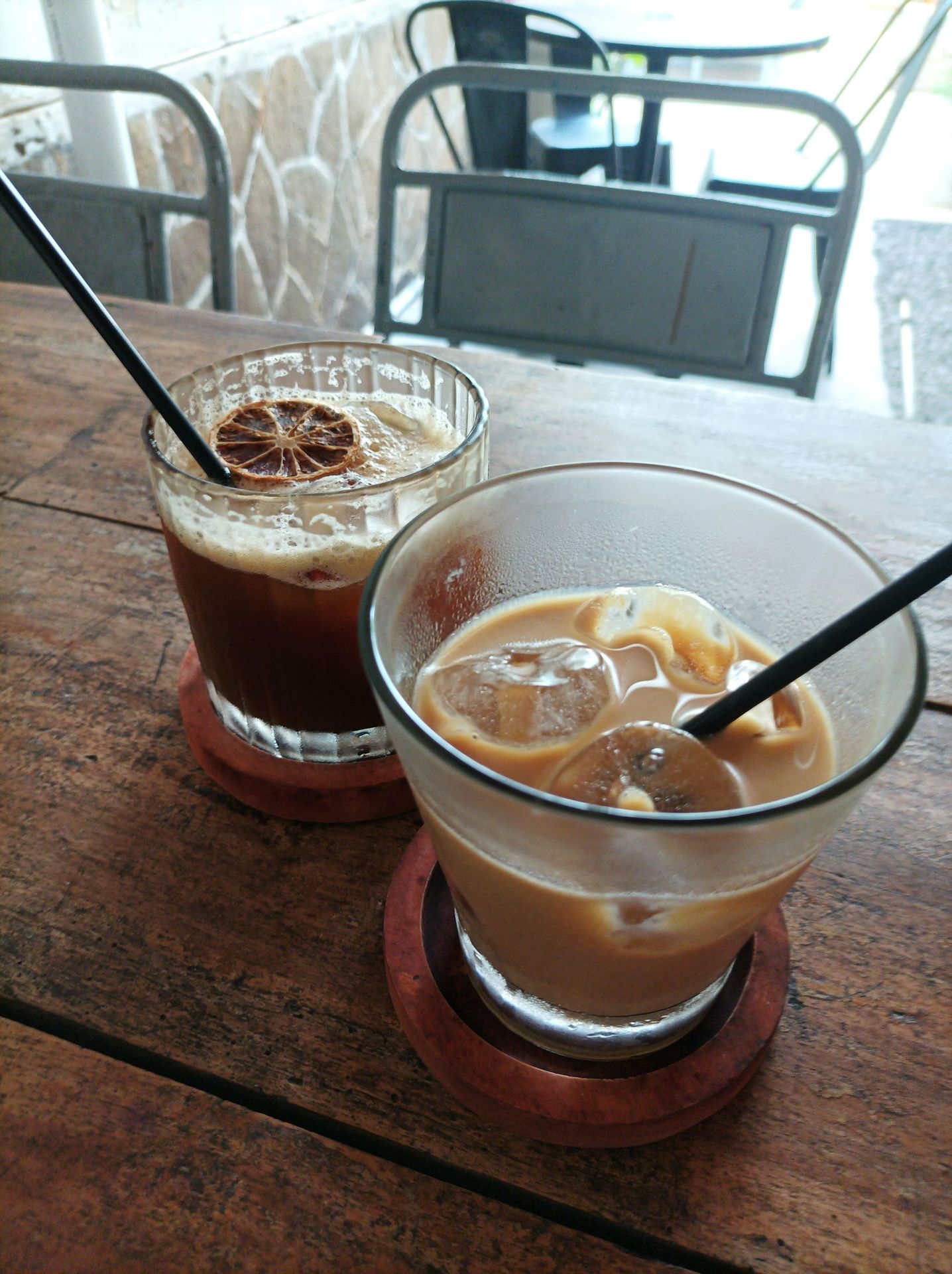 A couple of drinks sitting on top of a wooden table