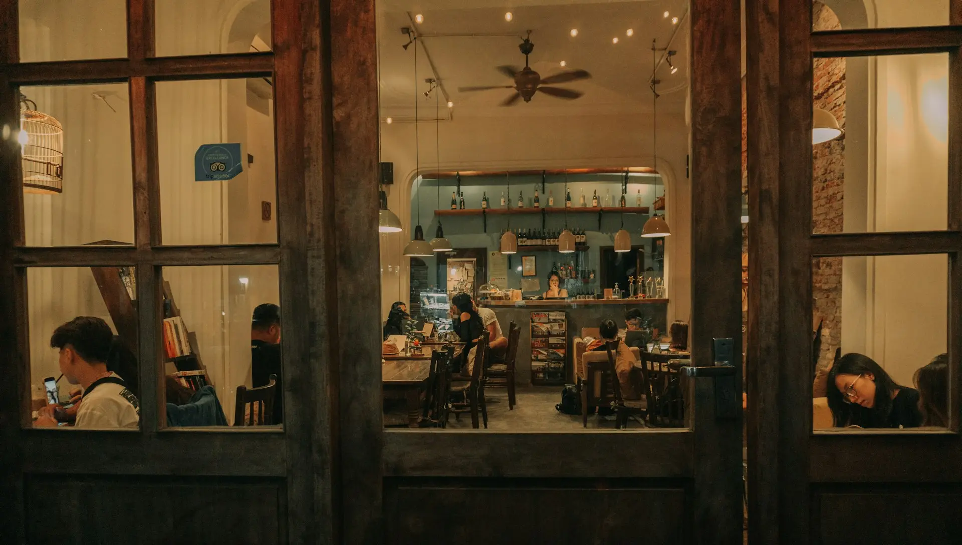 a group of people sitting at a table in a restaurant